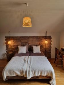 Saint-Amand-JartoudeixBon Chez Nous的一间卧室设有一张带砖墙的大床