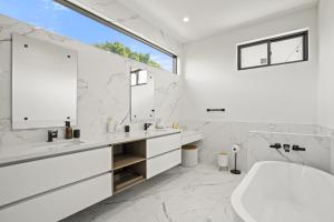 洛杉矶New Lavish Elegant 3BR Home in Mar Vista, Pet Friendly! 10min to Venice Beach!的白色的浴室设有浴缸和水槽。