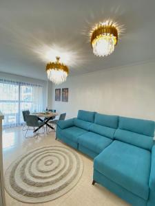 比利亚霍约萨Apartamento Familiar的客厅配有蓝色的沙发和桌子
