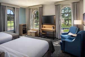 OronoHotel Ursa的酒店客房设有一张床、一张书桌和一台电视机。