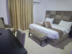 莱基Admiralty Hotel的一间卧室配有一张大床和一把椅子