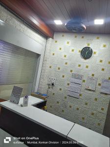 孟买ASRA DORMITORY For Male And Female的墙上挂着时钟的墙