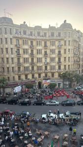 开罗Sama hotel的停车场内停放汽车的大型建筑