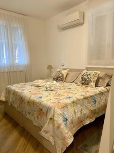 阿拉西奥Holiday Rooms La Campagnetta的一间卧室配有一张带毯子的大床