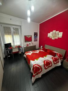 卡利亚里Affittacamere Sa Pardula的卧室设有红色墙壁、一张床和一张书桌