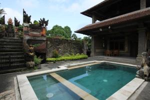 乌布Belvilla 93916 Budi House Near Ubud Palace的房屋后院的游泳池