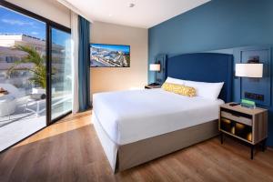 阿德耶Princess Inspire Tenerife - Adults Only的一间带大床的卧室和一个阳台