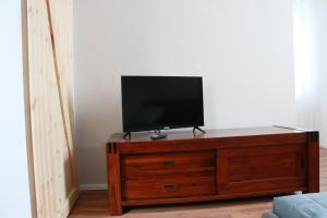 奥格斯堡KS Home的木质梳妆台上方的平面电视