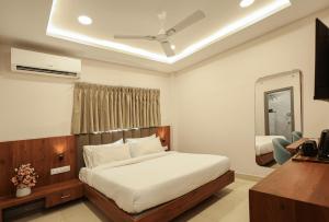 哈里瓦Arjun - A boutique hotel的一间卧室配有一张床和吊扇