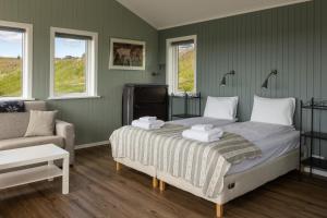 海拉海斯埃玛尔酒店的一间卧室配有一张床、一张沙发和窗户。
