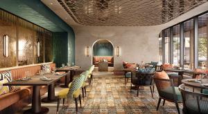 迪拜Avani Plus Palm View Dubai Suites的一间在房间内配有桌椅的餐厅