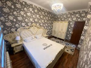 费尔干纳Квартира 3-ух Комнатная в центре города的卧室配有白色的床和花卉壁纸