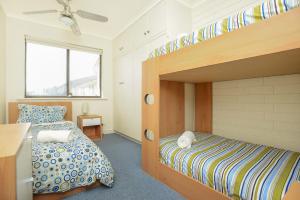埃利奥特港南海海滨公寓 的一间卧室配有一张双层床和一张双层床,提供
