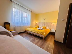 克雷尼察Górska Przystań SPA的一间卧室设有两张床,窗户拥有黄色的墙壁。
