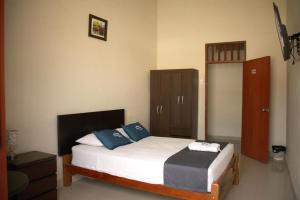 皮乌拉Estancia Real的一间卧室配有一张带蓝色和白色枕头的床