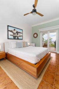 西湾Blue Roatan Resort的一间卧室配有一张大床和吊扇