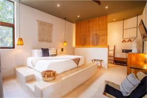圣法兰西斯克Agua de Luna Boutique Hotel的卧室配有一张白色大床和一把椅子