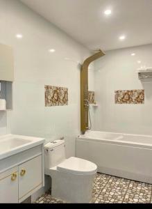 Ap Rạch SoiKhách Sạn Phụng Vy的白色的浴室设有卫生间和浴缸。