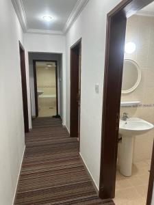 科威特Pyramiza Fahaheel的走廊上的浴室设有水槽和镜子