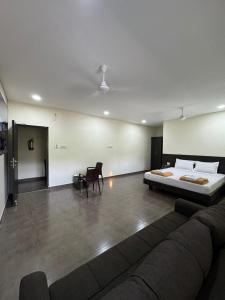 钦奈Sangeetha Business Hotel的客厅配有床和沙发