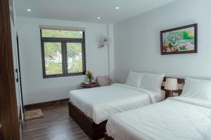 吉婆岛Charming Hill Hotel的一间卧室设有两张床和窗户。