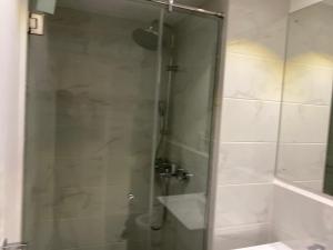 阿克拉Splendid Apartments - Embassy Gardens的浴室里设有玻璃门淋浴