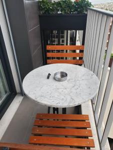地拉那Central Luxe Apartment的阳台上配有一张白色的桌子和两把椅子