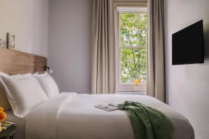 伦敦Sonder The Gilbert的卧室配有白色的床和窗户