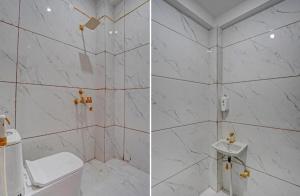 诺伊达icyhotels Hotel Exotic 58的一间带卫生间和大理石墙的浴室