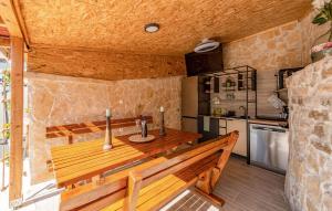 SmrdeljeNice Home In Zemunik Donji With Kitchen的一间厨房,在房间内配有木凳