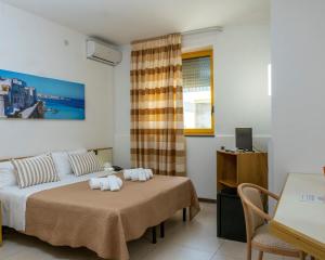 圣凯撒利亚温泉圣塔露西亚酒店的一间卧室配有一张床、一张书桌和一个窗户。