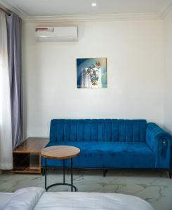 阿奴古Duplex16的客厅配有一张蓝色的沙发,配有一张桌子