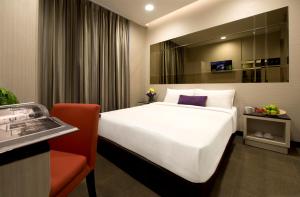 新加坡V Hotel Bencoolen的卧室配有一张白色大床和红色椅子
