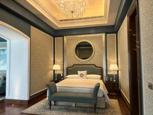 穆索里Welcomhotel by ITC Hotels, The Savoy, Mussoorie的一间卧室配有一张床和一个吊灯
