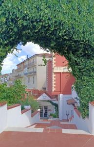 Francavilla in SinniAlbergo Mango的透过树拱的建筑景观
