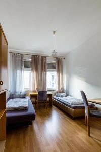 开姆尼茨Apartmenthaus in Chemnitz für Monteure的一间卧室配有两张床和一张桌子及椅子
