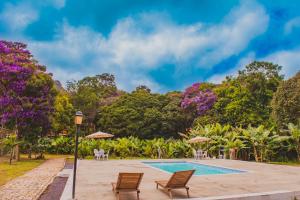 韦尔卡鲍Villaflor Pousada的一座带椅子和树木的度假游泳池
