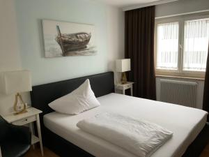 塞基兴Hotel Berg的一间卧室配有一张带白色枕头的床
