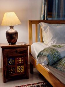 比尔瓦La Maison - A Boutique Bed and Breakfast的一间卧室,配有一张床和床头灯