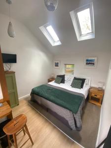 凯西克Claremont House Keswick的一间卧室设有一张床,天花板上设有天窗。