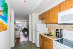 檀香山Ilikai Marina 1383 City View Studio的厨房配有水槽和白色冰箱