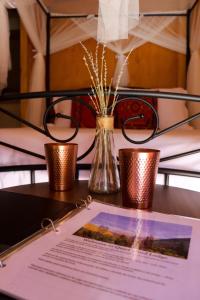 克恩维尔Quiet Mind Lodge, Spa & Retreat Sequoias的一张桌子,上面有两根蜡烛和一张纸