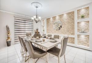瓜亚马DC Luxury House的一间配备有白色桌椅的用餐室