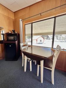 布里奇波特Willow Springs Resort的一间带桌椅和窗户的用餐室