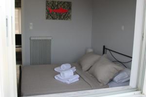 希俄斯Sunrise View Apartment的一间设有床铺和毛巾的房间