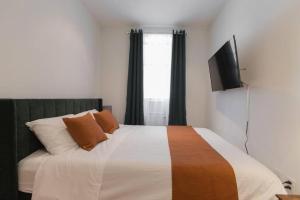 纽约Magnificent 5 Bedroom Apt in NYC!的一间卧室设有一张带平面电视的床。