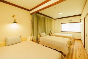 温泉津川の灯的酒店客房设有两张床和窗户。