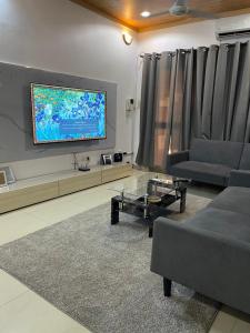 瓦加杜古Glorymienmo的带沙发和平面电视的客厅