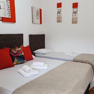 林多亚Pousada irmãos Oliveira的客房内的两张床和毛巾