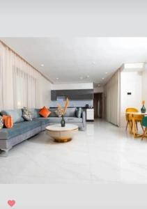 卡萨布兰卡Maarif Elite Suites的客厅配有蓝色的沙发和桌子